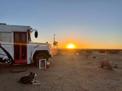 Sunset in the desert at a Tiny House Skoolie Vacation Rental: Homesteading with Dogs