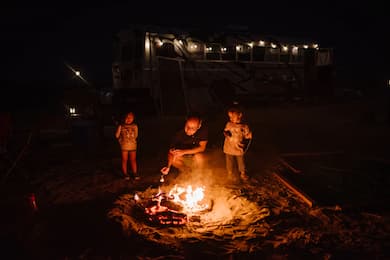 Kids Roasting Smores at a campfire with a grown-up. Desert Bonfire Family Friendly Events in Los Angeles
